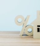 Percentage sign and Model House on blue background
